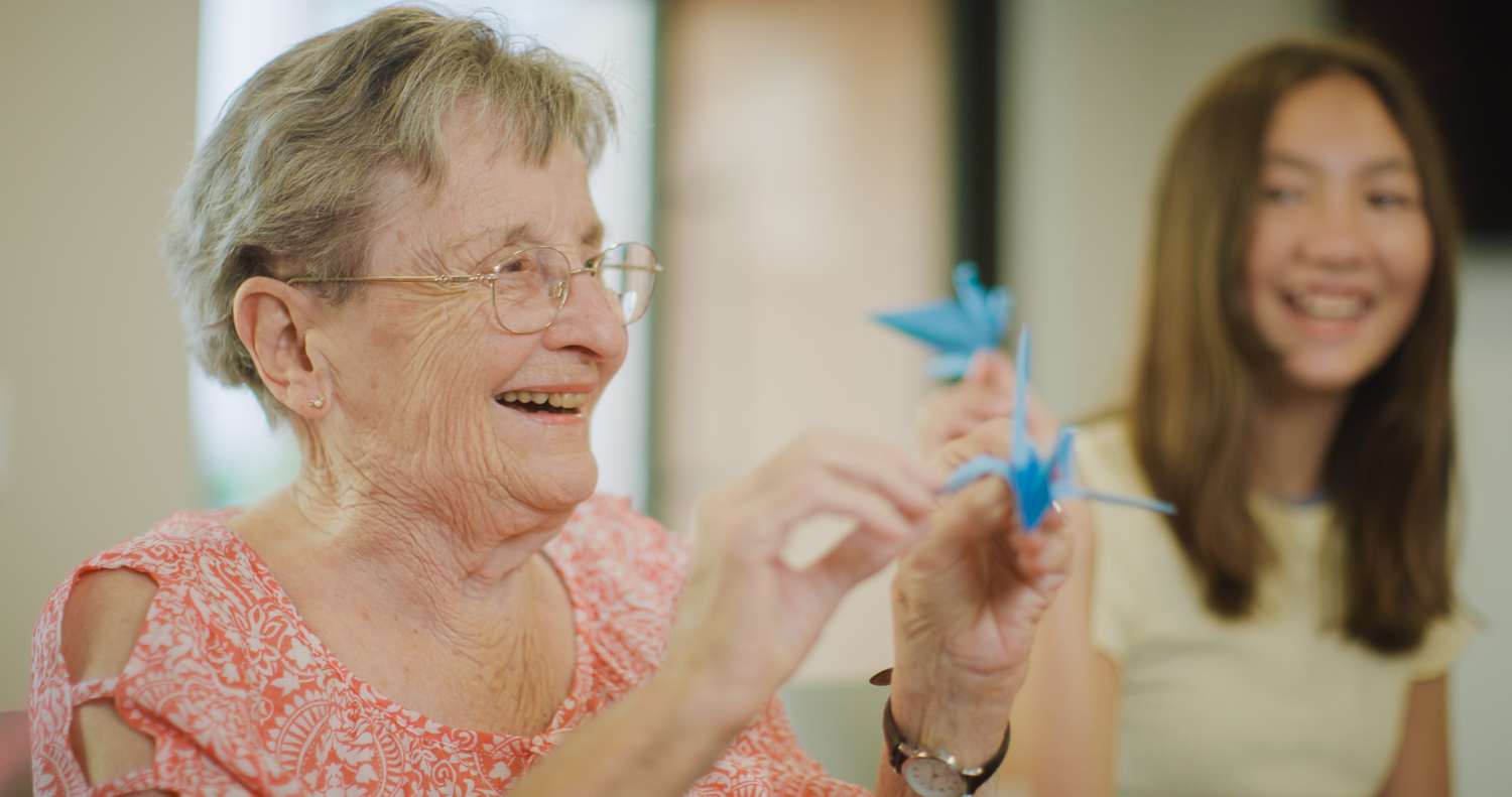 Senior woman with an origami bird