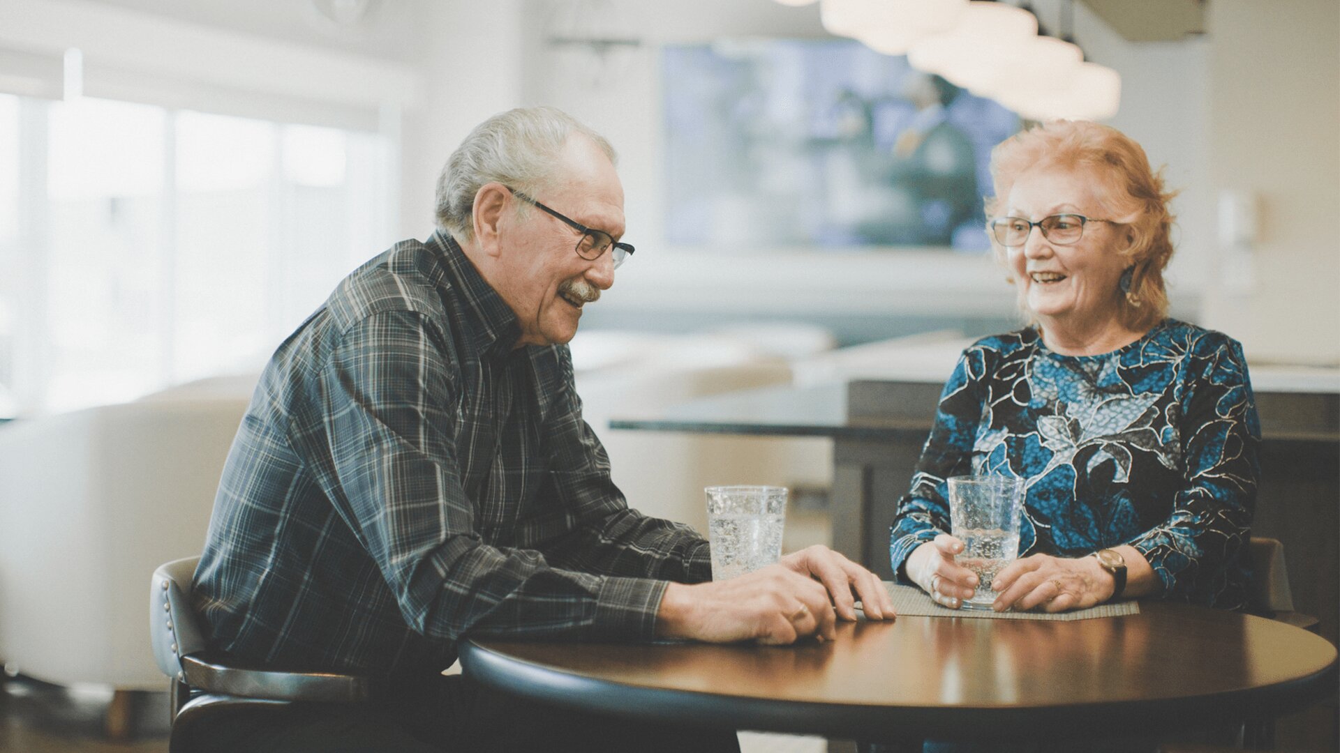 A happy elderly couple drinking water