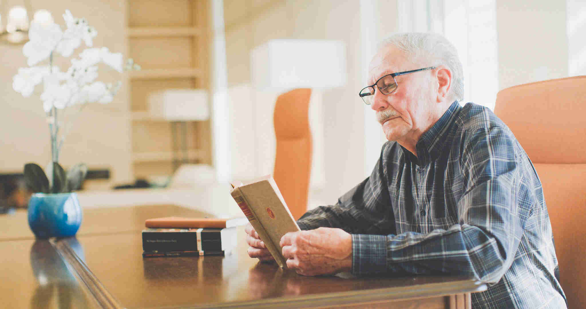 A senior man reading a book