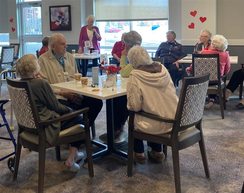 Seniors enjoying Valentine's Day together with drinks and decorations