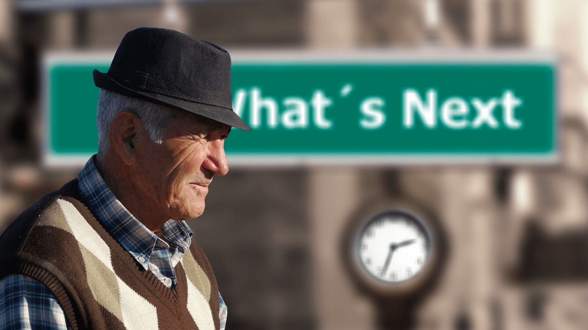 An elderly man wearing black hat