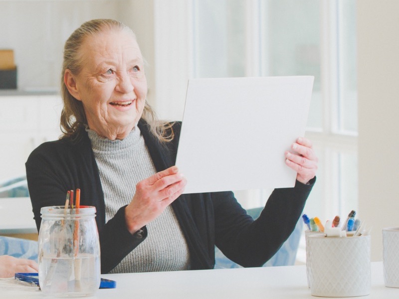 An elderly lady painting, a fun activity for seniors