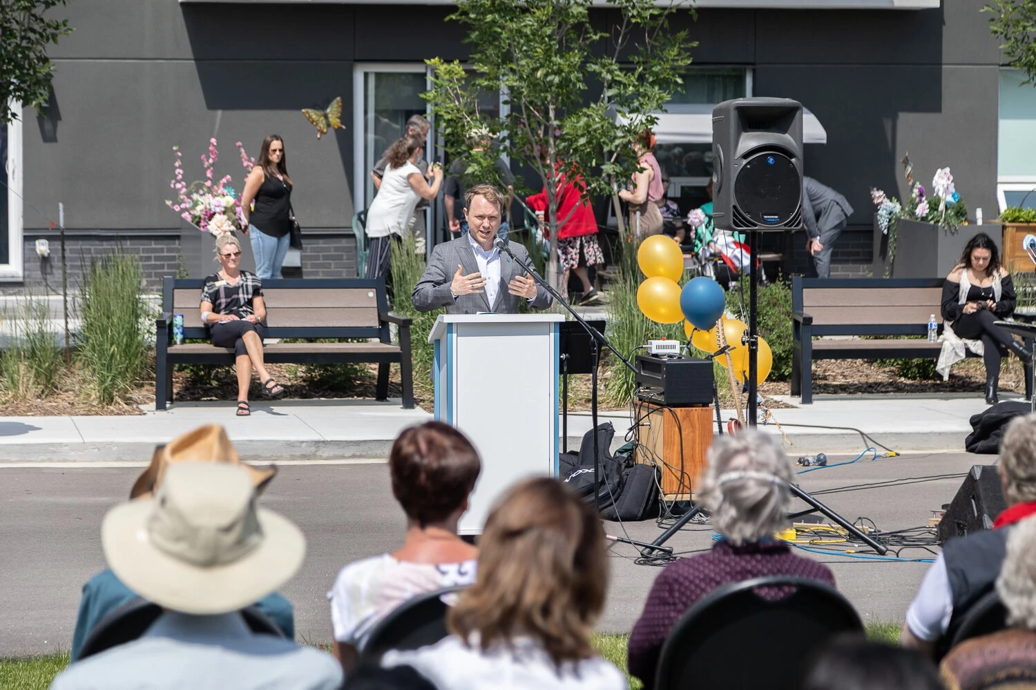 A picture of a man giving speech on grand opening ceremony