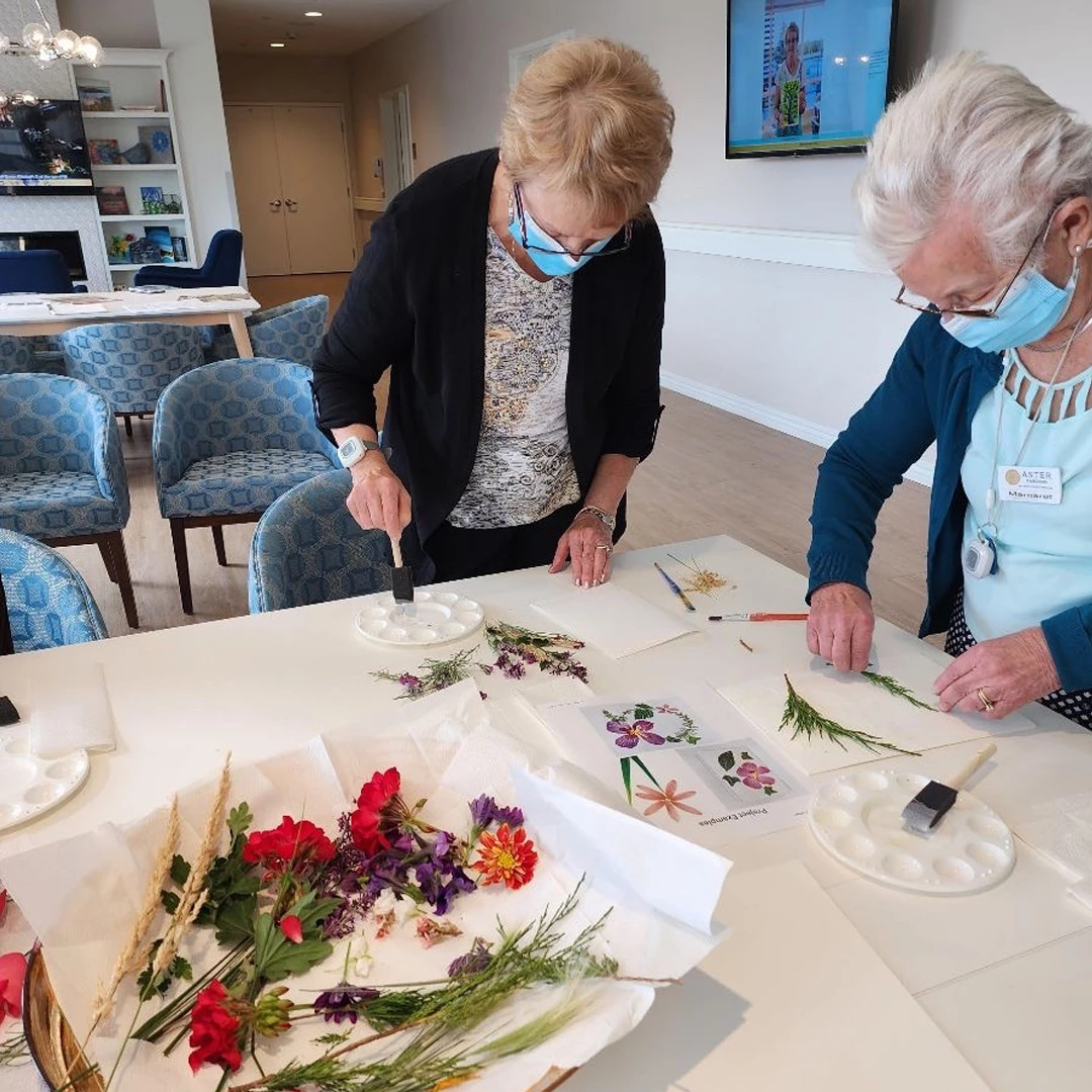 Two elderly women painting