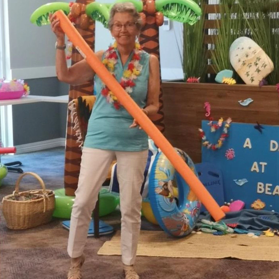 An elderly lady enjoying at the beach party