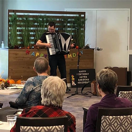 A man singing and playing musical instrument on birthday party