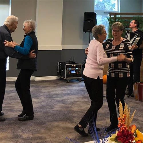 Some elderly people dancing on birthday party