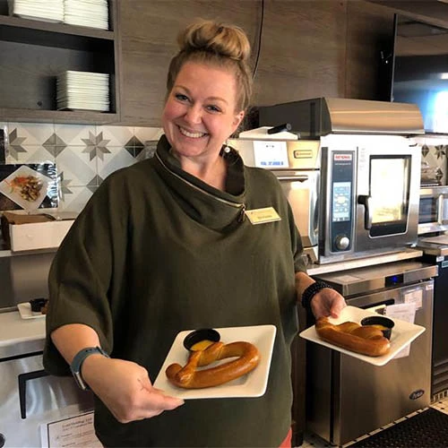 A lady serving donuts