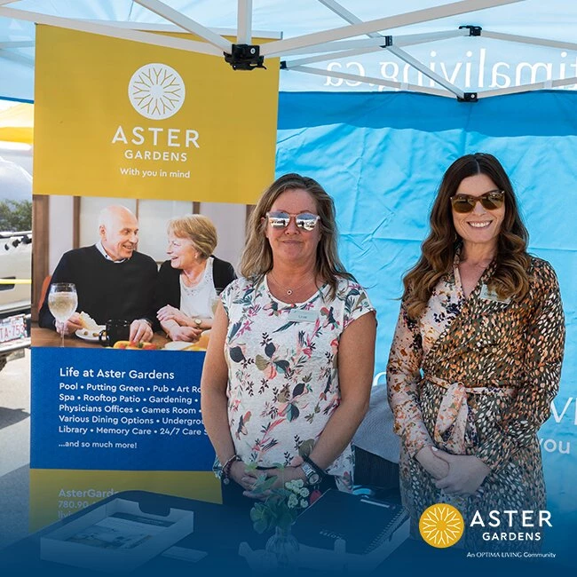 Two ladies standing at Optima living's booth