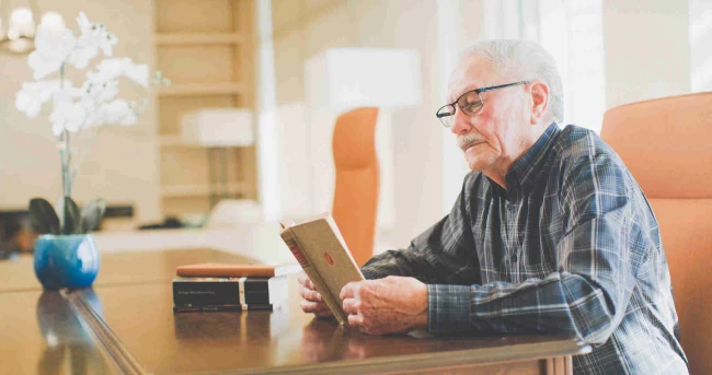 A senior man reading a book