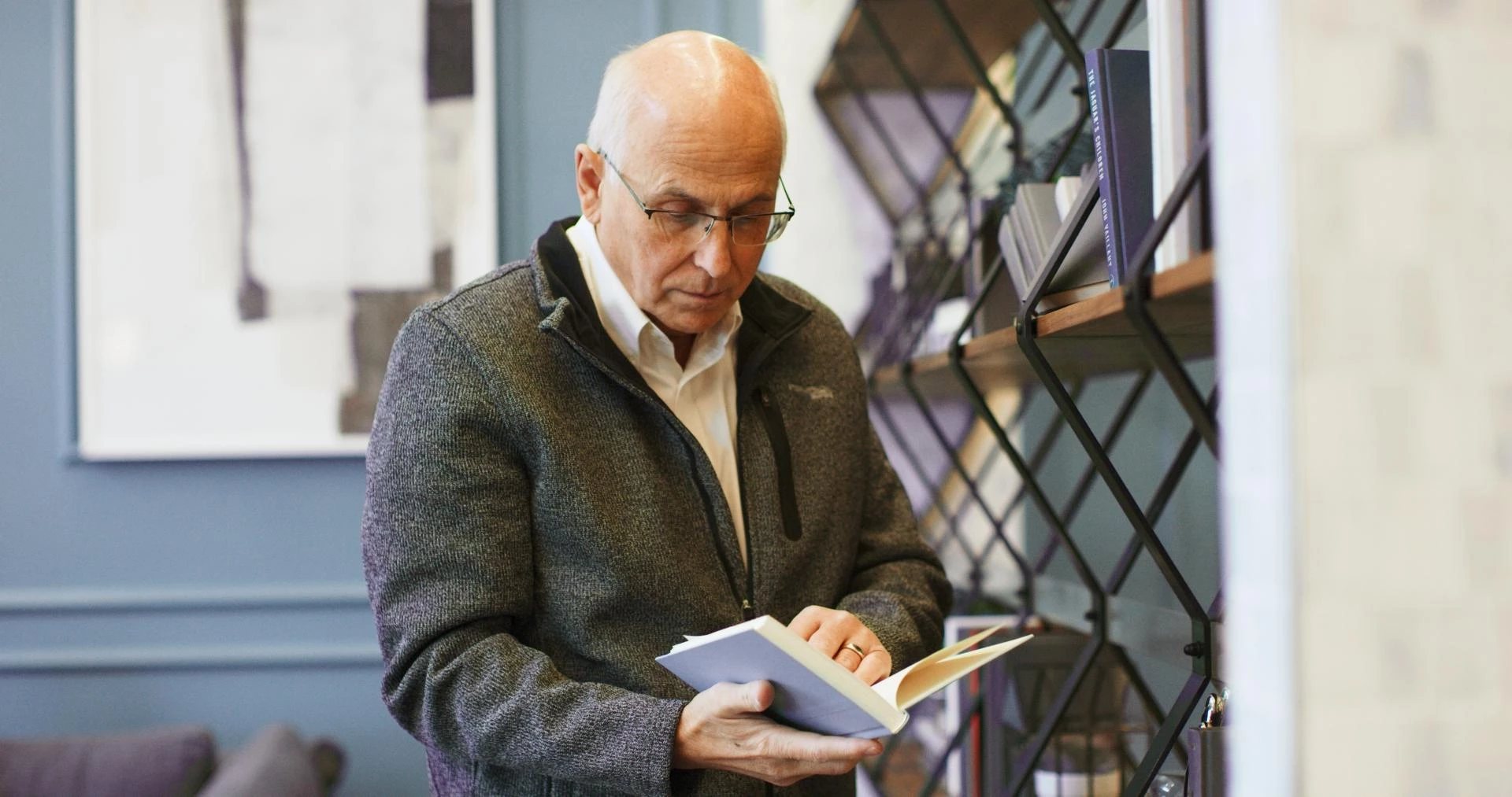 An elderly man while reading a book at Aster Gardens