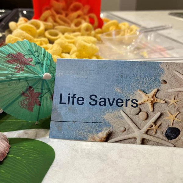 Postcard next to some food, the post card says